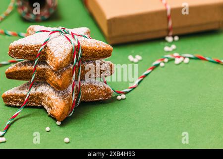 Homemade star shaped Christmas cookies on green background close-up Stock Photo