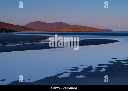 Sunset over Luskentyre Beach at low tide on the west coast of the  Isle of Harris. Stock Photo