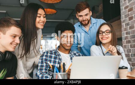 Diverse Group of Young Adults Collaborating on a Project Stock Photo