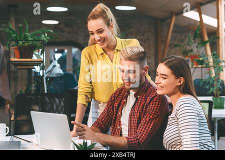 Young Professionals Collaborating on a Project in a Modern Office During the Day Stock Photo