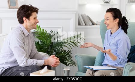 Man and Woman Engaging in Conversation During Daytime Counseling Session Stock Photo