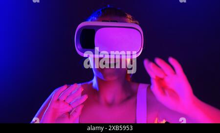 Woman Wearing Virtual Reality Headset in Neon Light Stock Photo