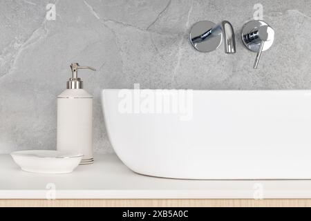 Contemporary bathroom sink with white soap dispenser and soap dish on gray tiled background. Stock Photo