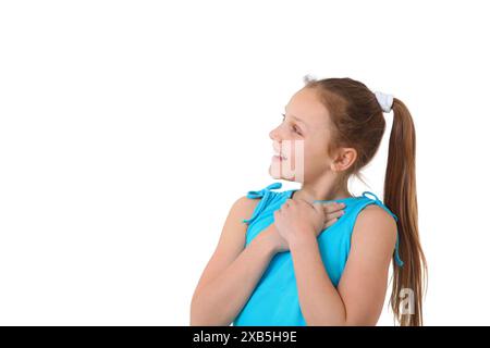 cheerful preteen girl pointing  and looking  to the side at at copy space on white background Stock Photo