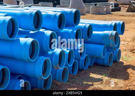 On construction site, there are blue PVC pipes for laying pipe water system to new house Stock Photo