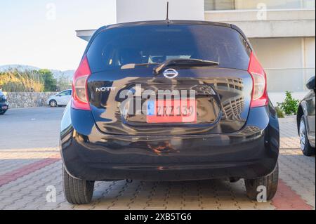 Gaziveren Cyprus 05.27.2024 - black Nissan Note in the parking lot outside the house 1 Stock Photo