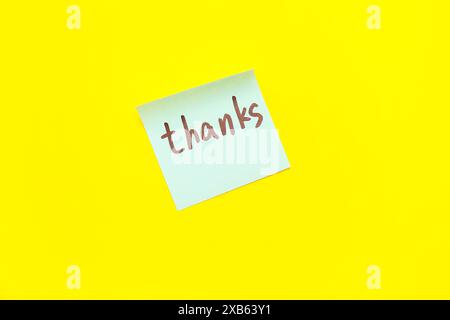 Sticky note with word THANKS on yellow background Stock Photo