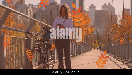 Young Caucasian man standing on bridge looking at his smartphone Stock Photo