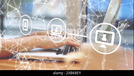 Hands typing on laptop keyboard with digital network icons on screen Stock Photo