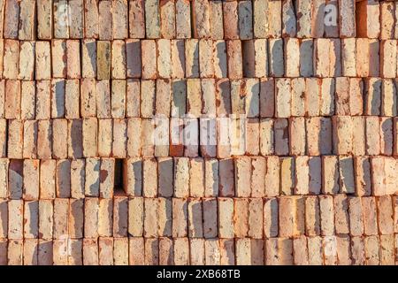 Red bricks stacked on top of each other. Background for construction. Stock Photo