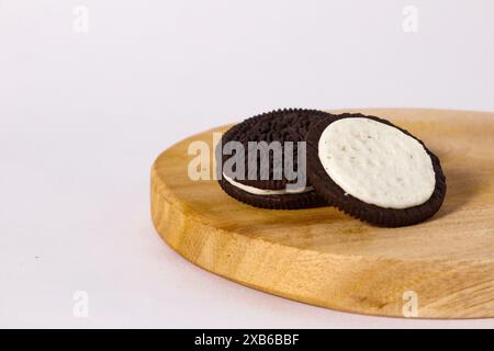 Crispy chocolate biscuits with vanilla cream inside, children's favorite fast food snack Stock Photo
