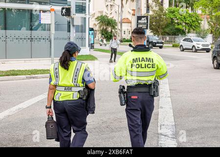 Miami Florida,Biscayne Boulevard,police policeman policewoman,wearing reflective vest,public service aide,street scene,man men male,woman women lady f Stock Photo