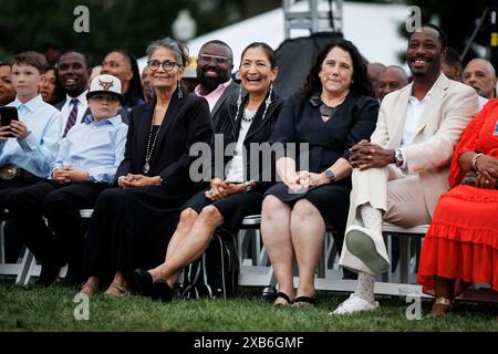 Washington, United States. 10th June, 2024. Deb Haaland, US secretary of the interior, center, and Isabel Casillas Guzman, administrator of the US Small Business Administration (SBA), second right, attend a Juneteenth concert on the South Lawn of the White House in Washington, DC on Monday, June 10, 2024. In 2021, Biden signed legislation establishing Juneteenth as the nation's newest Federal holiday. Photo by Ting Shen/UPI Credit: UPI/Alamy Live News Stock Photo