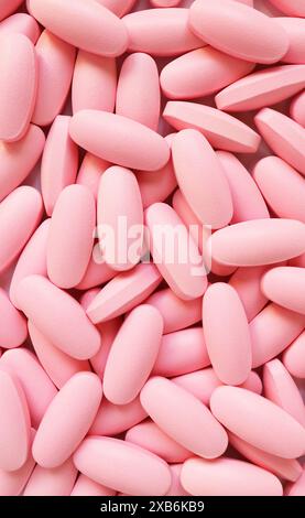 Heap of pink oval shaped pills for the concept of medical Stock Photo