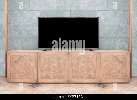 LCD led tv with blank black screen standing on wooden television cabinet Stock Photo