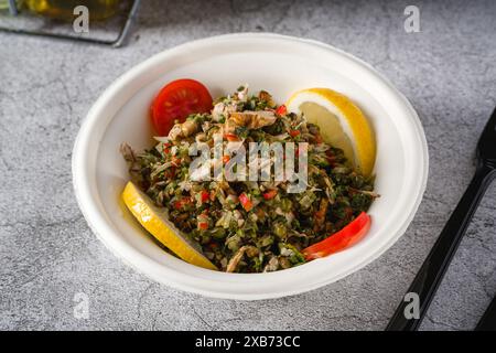 Healthy salad with capers, quinoa and walnuts on stone table Stock Photo