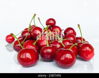 Sweet cherry fruit (Prunus avium) close-up isolated on white background with reflection Stock Photo