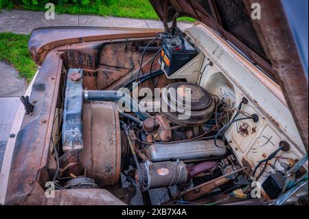 A vintage car parked on sidewalk with various items inside Stock Photo