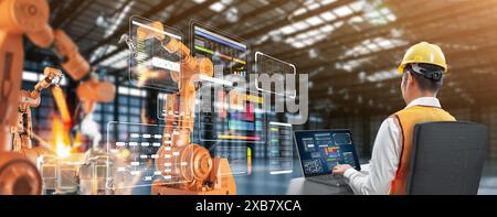 Technician or engineer work with robotic arms in factory Stock Photo