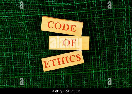 Code of ethics text on table, concept. code of ethics word written a conceptual phrase on wooden blocks top view Stock Photo