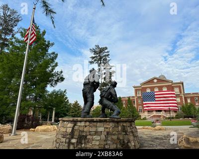 Memorial Day scene. Alpharetta City Hall adorned with a large US flag as seen from the war memorial Stock Photo