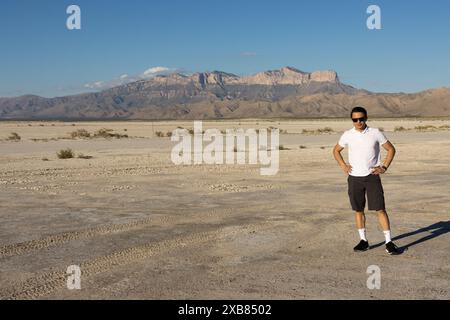 A Young man standing in front of Guadalupe Peak Stock Photo