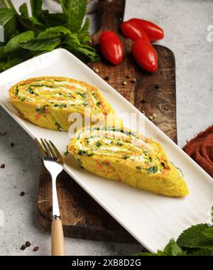 A variety of food with tomatoes and peppers on a plate Stock Photo