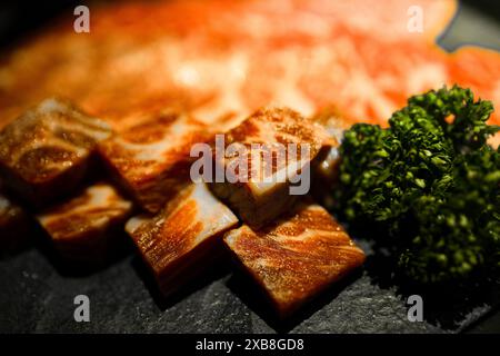 Chopped tofu and broccoli on black kitchen counter Stock Photo