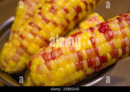 Close-up of three ears of corn garnished with ketchup Stock Photo
