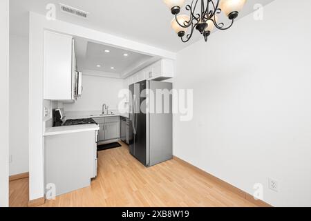 Spacious kitchen with elegant black chandelier Stock Photo