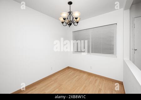 A chandelier hangs in the center of a room Stock Photo