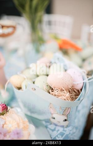 A vertical shot of Easter eggs displayed in a paper bunny bowl Stock Photo