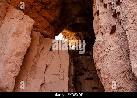 A small cave with holes in the rocks, providing a view from inside Stock Photo