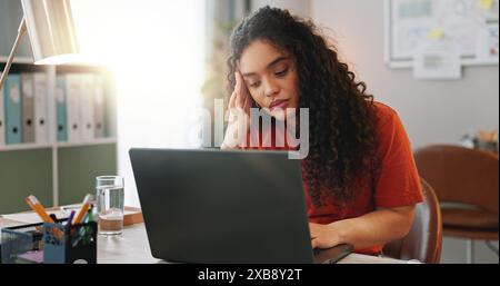 Headache, laptop and problem solving with designer woman in creative workplace for project management. Burnout. computer and stress with unhappy Stock Photo