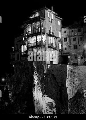 A vertical grayscale shot of the Hanging Houses in Cuenca, Spain Stock Photo