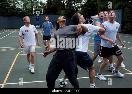 President Barack Obama, along with members of Congress and Cabinet secretaries, jockeys for a rebound during a basketball game on the White House court, Oct. 8, 2009. Official photo by Pete Souza, White House Stock Photo