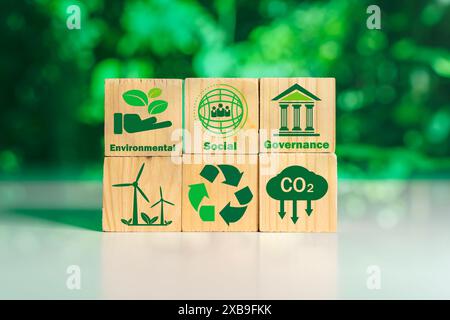 CO2 emission reduction concept.Sustainable development and business based on renewable energy.Green Energy icon on a wooden block for Energy saving an Stock Photo