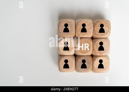 A group of wooden cubes with people on them and the letters HR on top. Concept of teamwork and collaboration Stock Photo