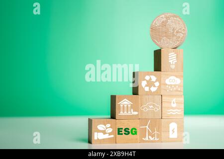CO2 emission reduction concept.Sustainable development and business based on renewable energy. Green Energy icon on a wooden block for Energy saving a Stock Photo