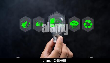 Energy efficiency concept. Businessman touching energy efficiency rating icon on virtual screen for energy efficient house building rate label audit. Stock Photo
