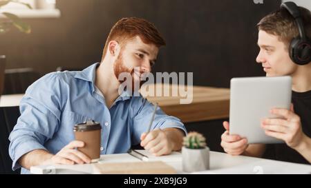 Smart student helping his classmate with homework Stock Photo