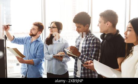 Young Professionals Engaged in a Collaborative Brainstorming Session Stock Photo