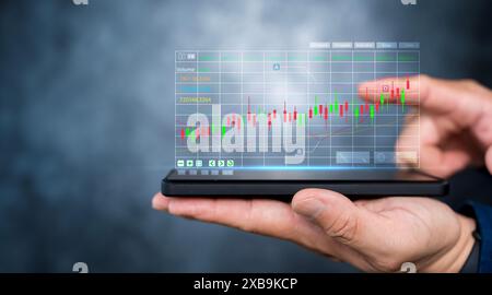 Trader use smartphone to analyzing growing stock on virtual screen for invest in trading. planning and strategy, Stock market, Business growth. Stock Photo