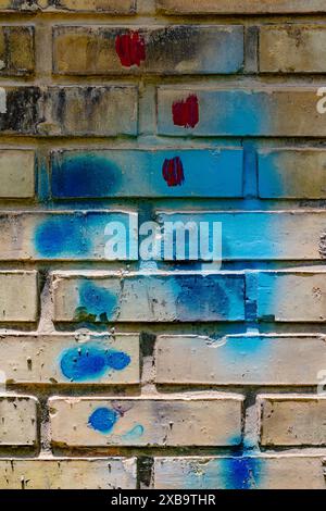 Random paint on brick wall. Stock Photo