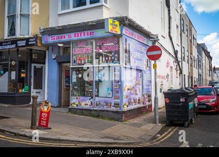 A traditional corner shop, or convenience store, selling foodstuffs and alcohol in Brighton, East Sussex, UK Stock Photo