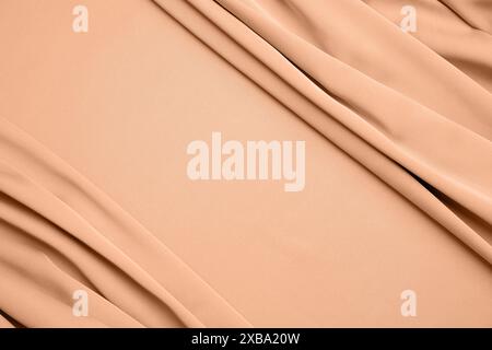 Peach fuzz color silk, top view. Trendy shade of 2024 year Stock Photo