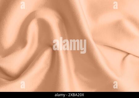 Peach fuzz color silk, top view. Trendy shade of 2024 year Stock Photo