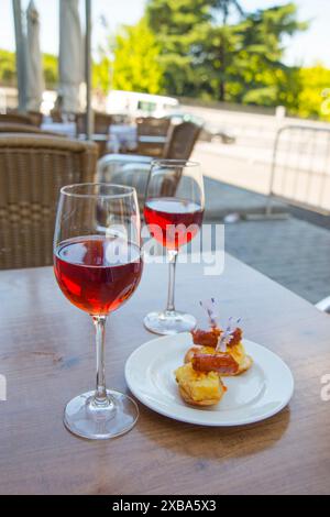 Two glasses of rose wine with tapa in a terrace. Madrid, Spain. Stock Photo