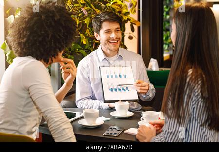 Managers analyzing chart at a business lunch Stock Photo