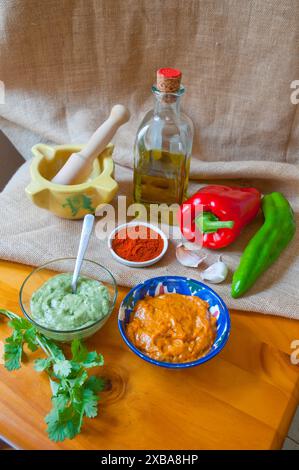Green mojo and red mojo with ingredients. Canary Islands, Spain. Stock Photo